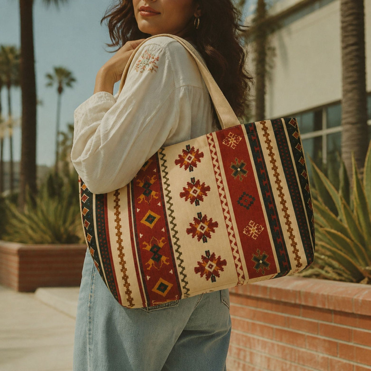 Sonora kilim tote bag carried along a palm-lined street