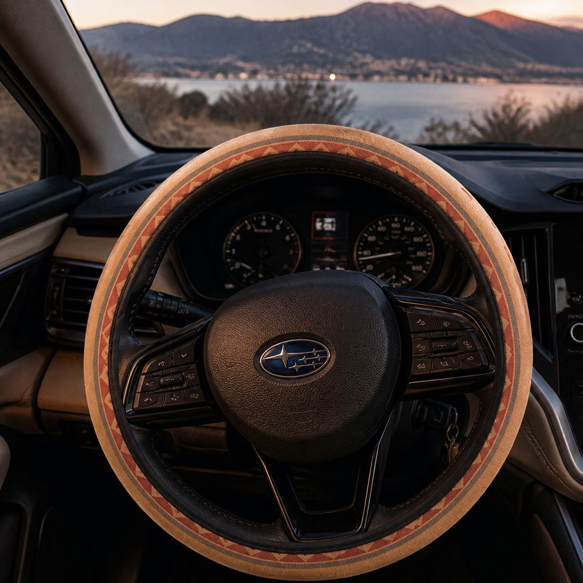 Indigo steering wheel cover by Solara on the wheel at dusk, lake and mountain view