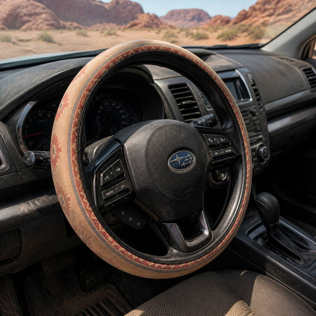 Indigo steering wheel cover by Solara, seen from the passenger side: cream Aztec print
