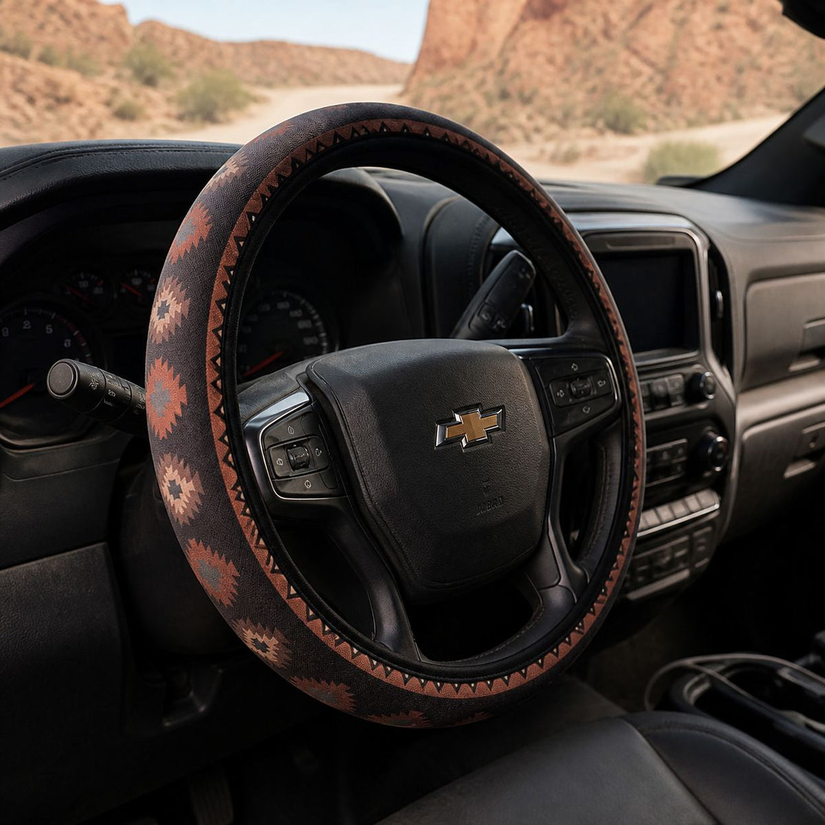 Zara steering wheel cover by Solara, seen from the passenger side: black and orange Aztec print
