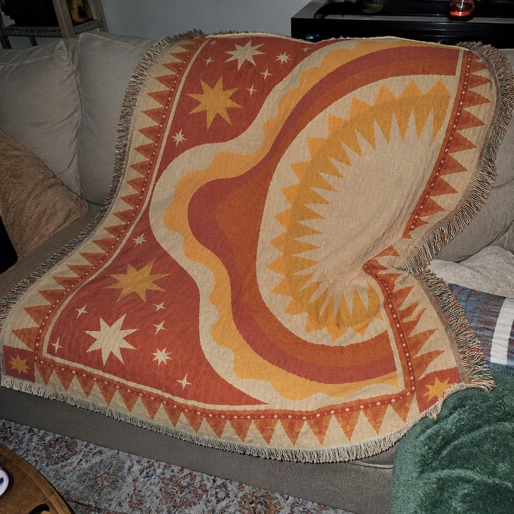 Woven boho blanket used as a beach rug