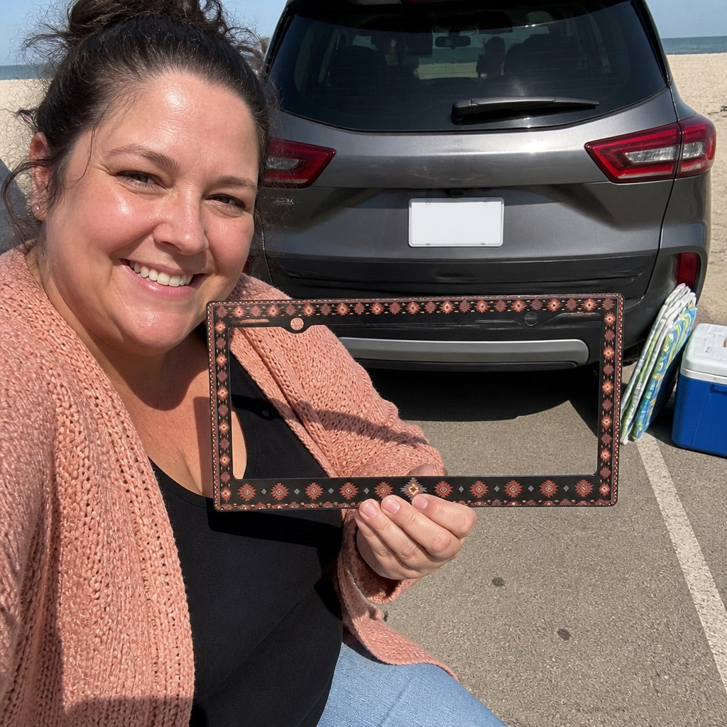 Black patterned license plate frame on a car
