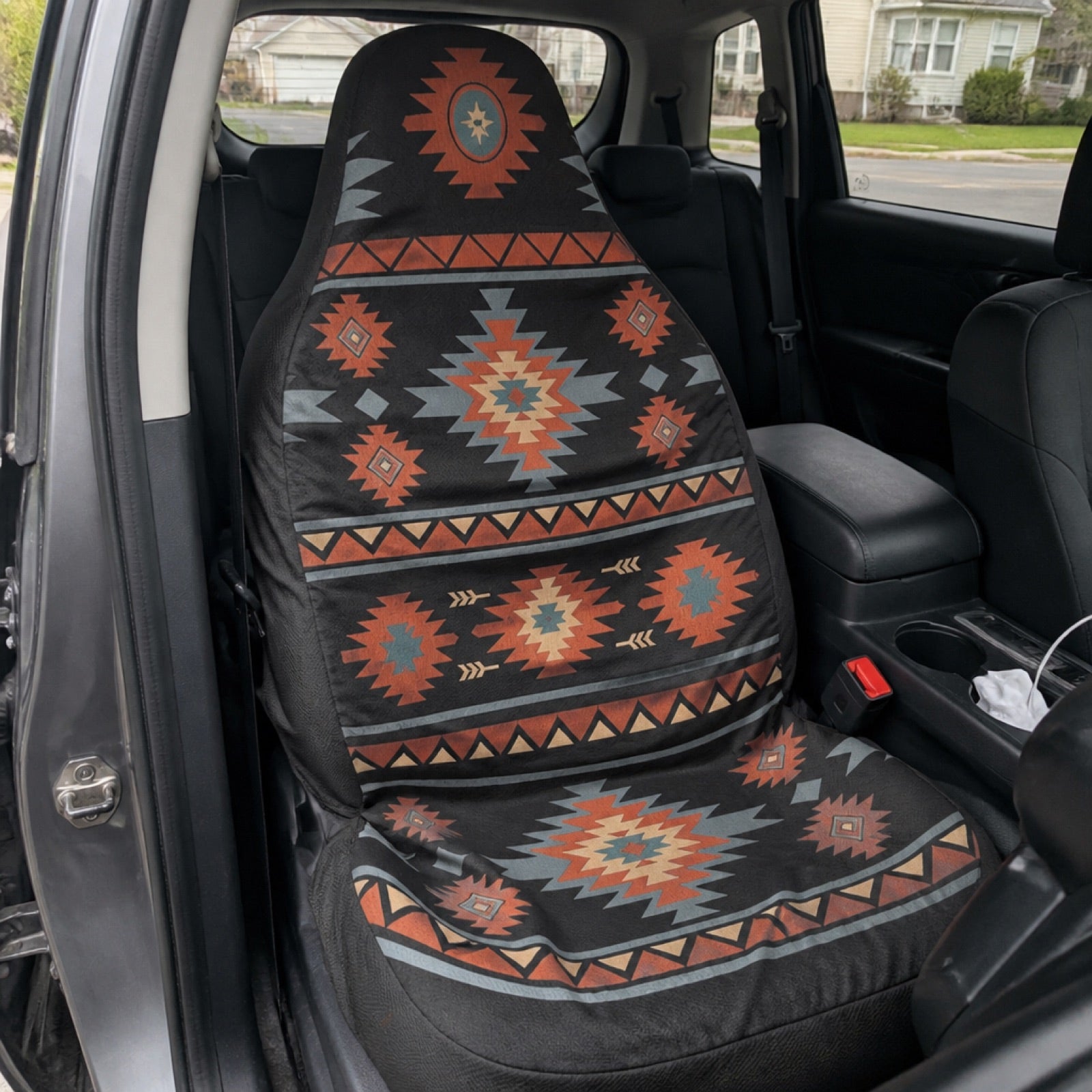 Black and orange Aztec seat covers in a midsize truck cab | Solara Covers