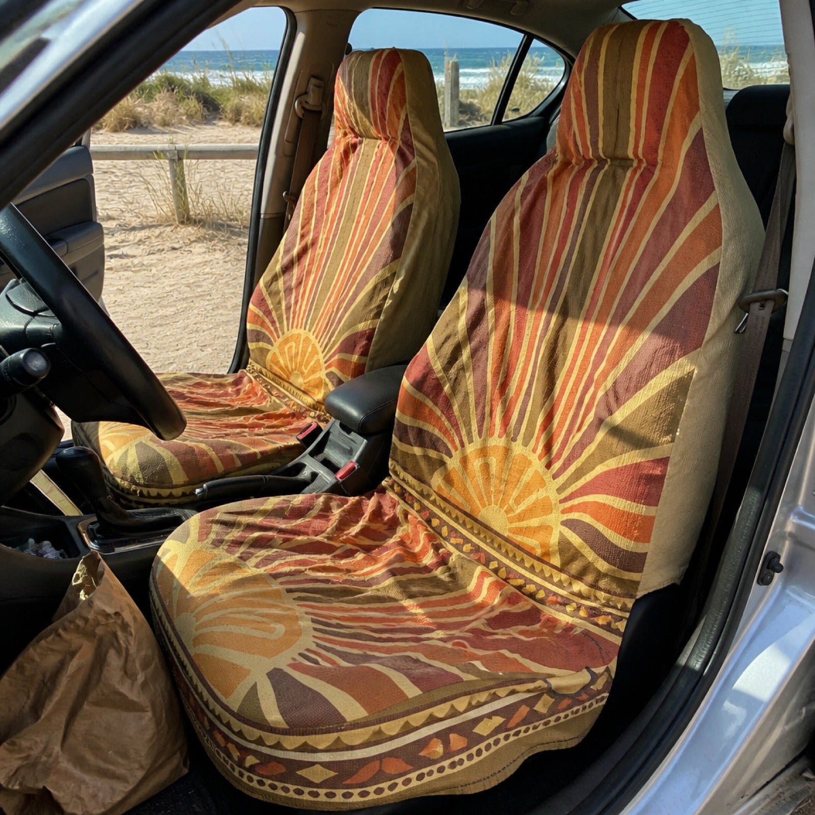 Boho seat covers installed on the front seats of a conversion van