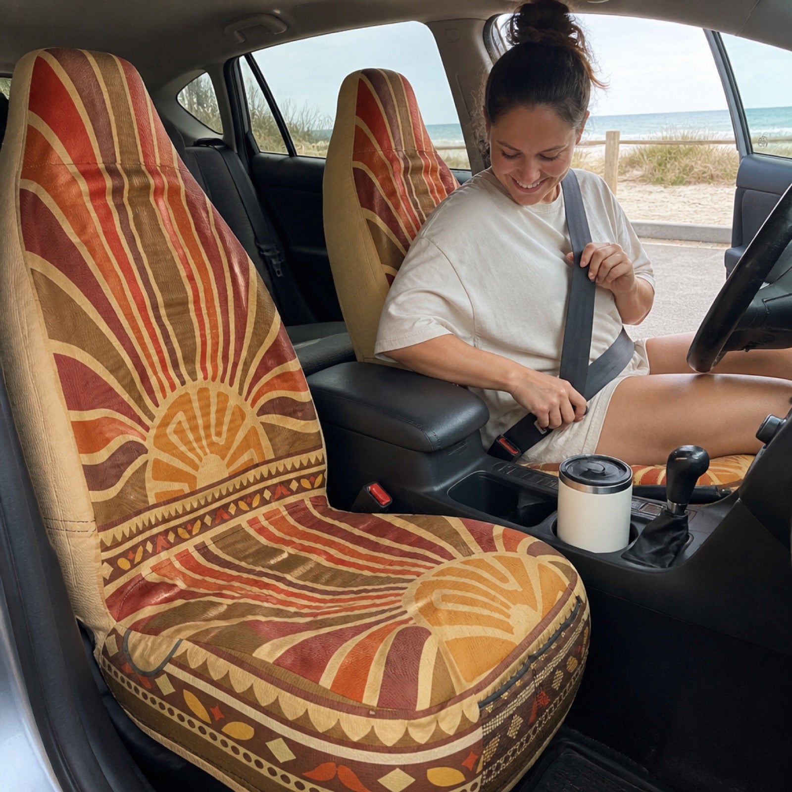 Sunrise print seat covers being installed in an open-air SUV | Solara Covers