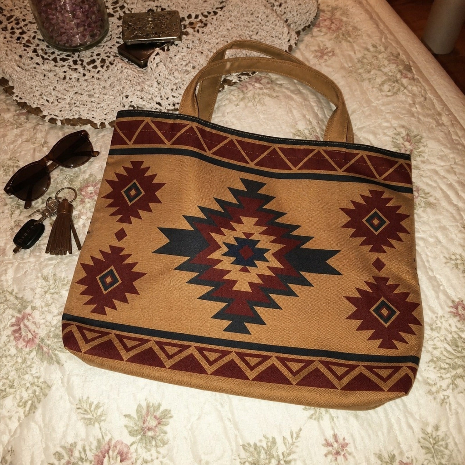 Boho canvas tote bag shown up close on a bed