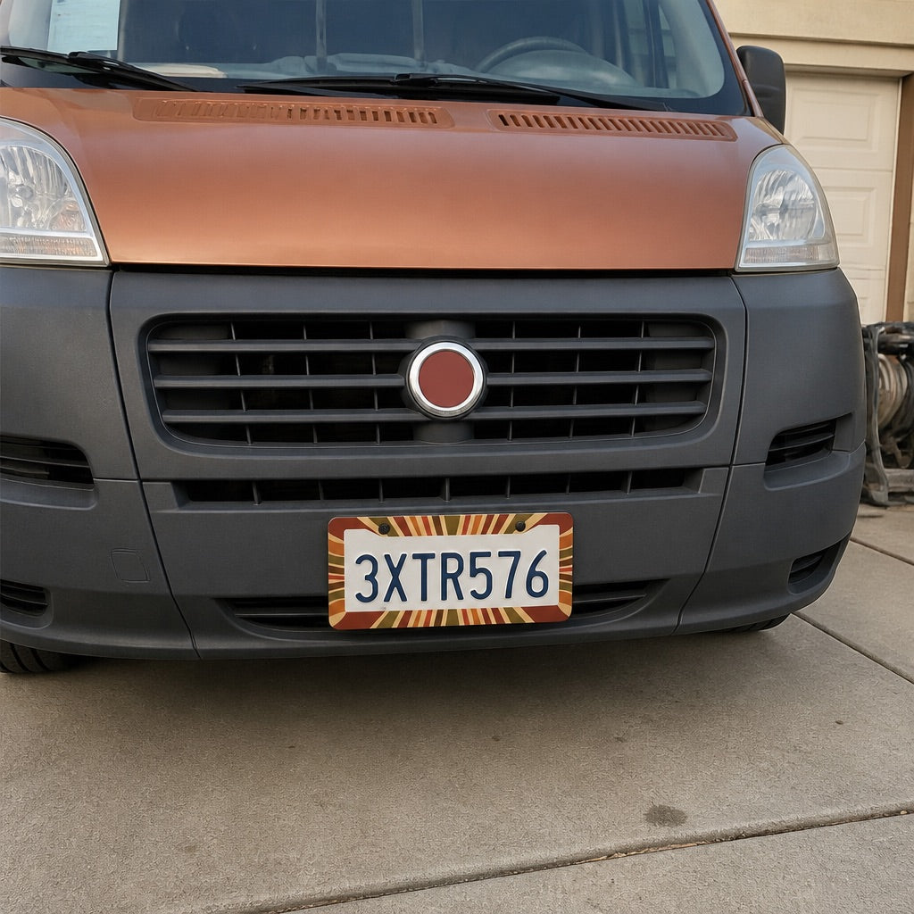 Patterned license plate frame held up next to a car