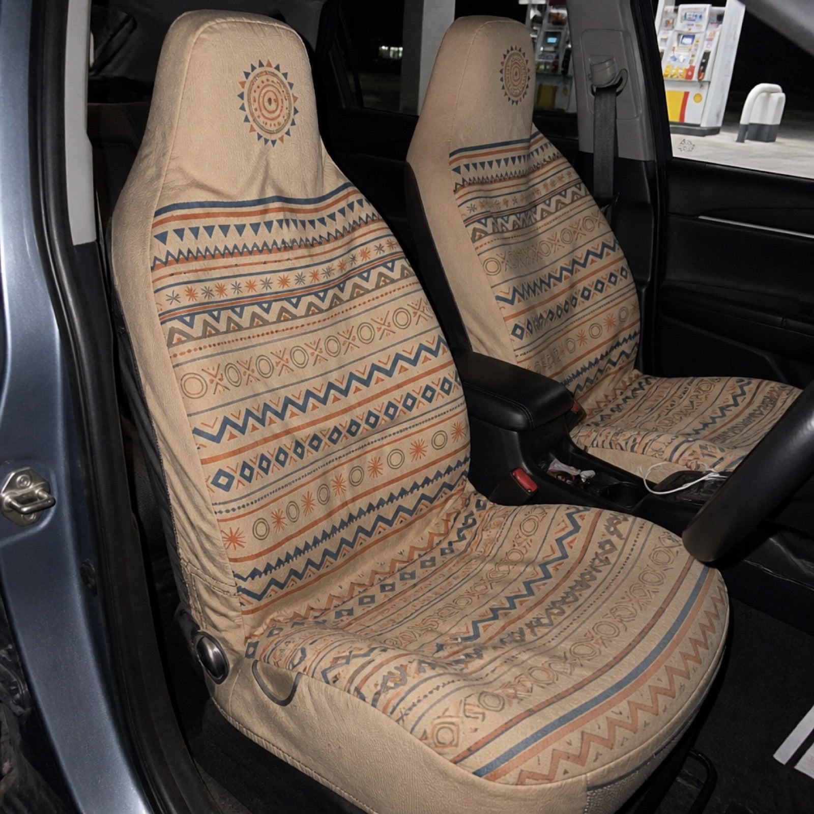 Warm-toned boho seat covers installed on a car's front seats
