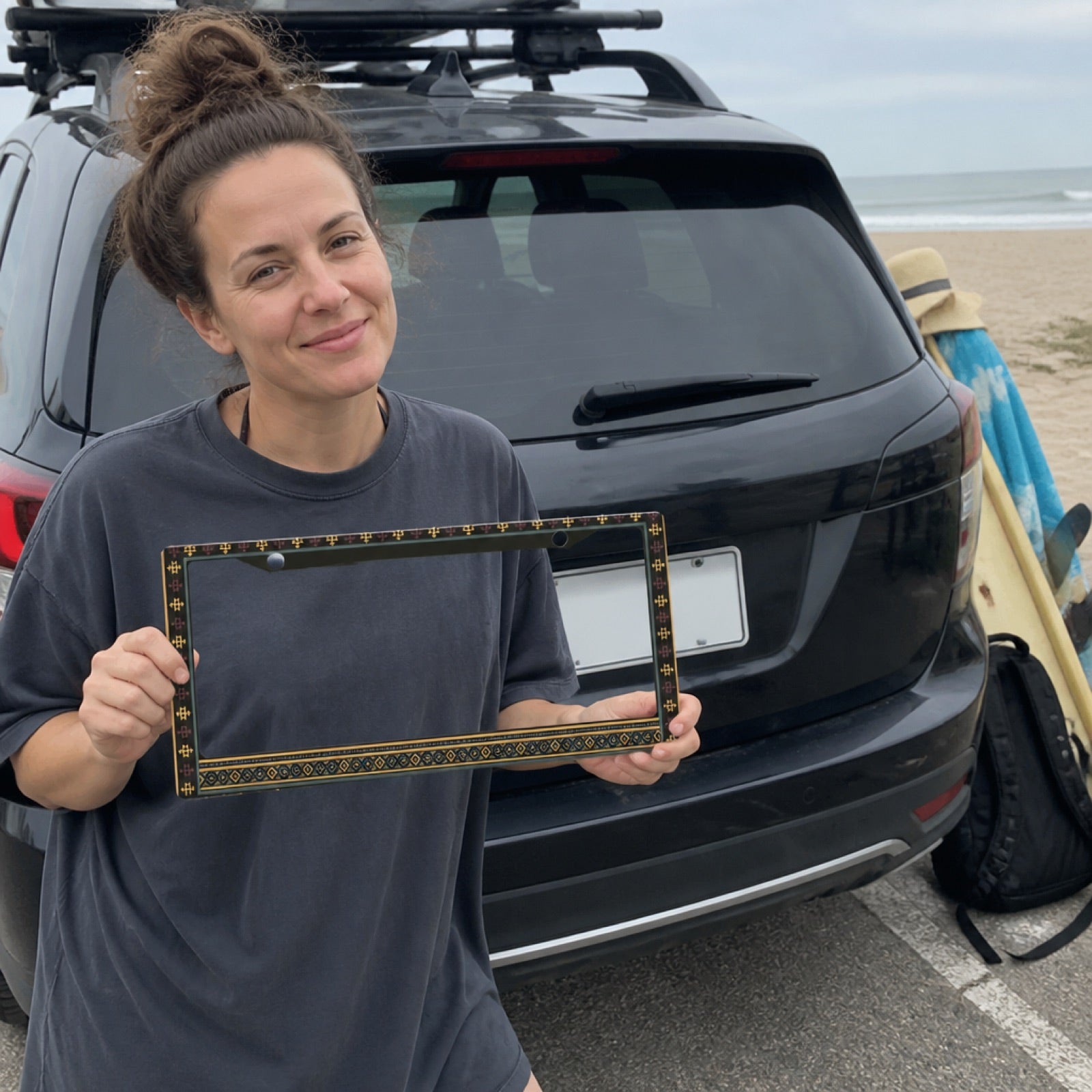 Solara license plate frame beside an SUV at the beach — road trip ready