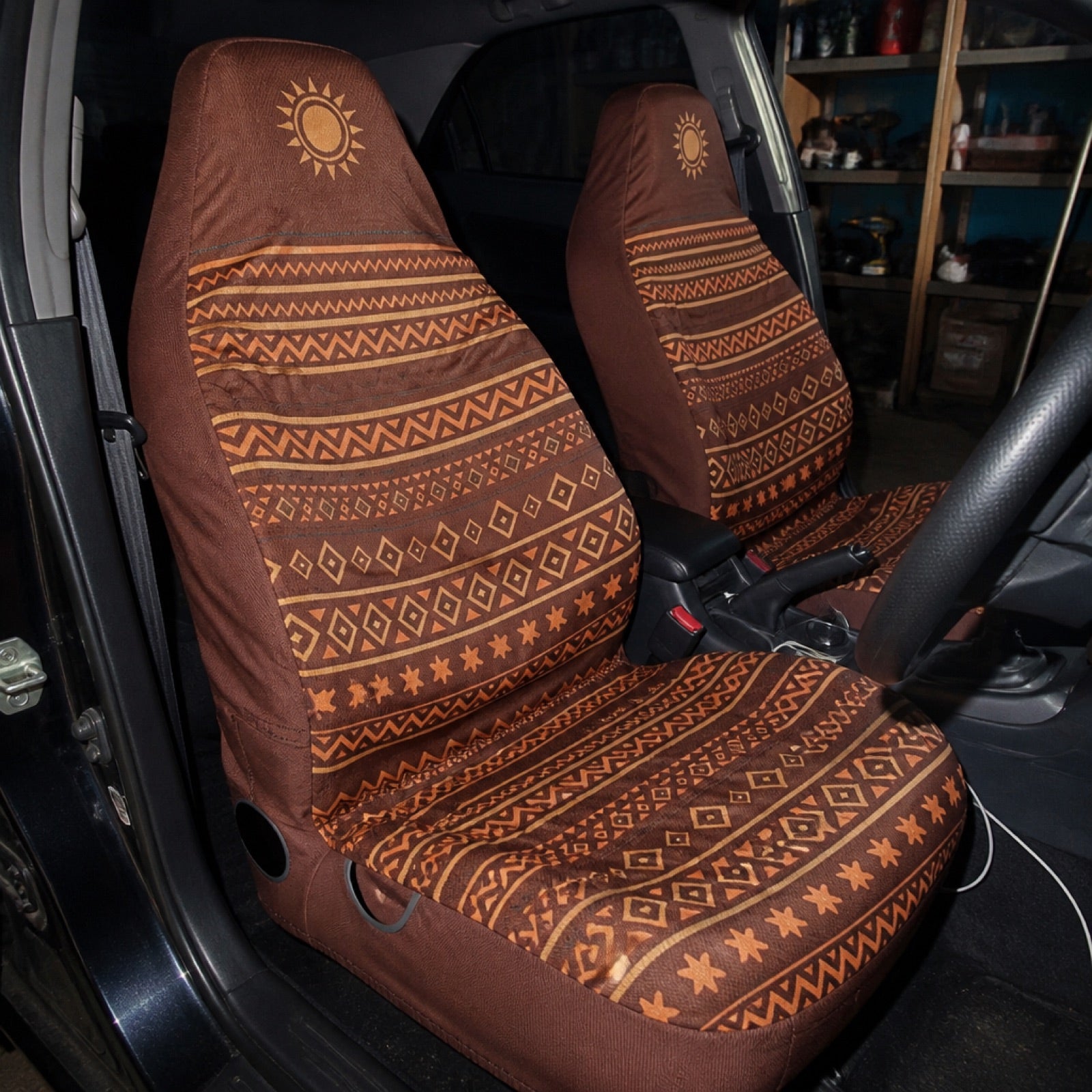 Boho seat covers installed on the front seats of a RV