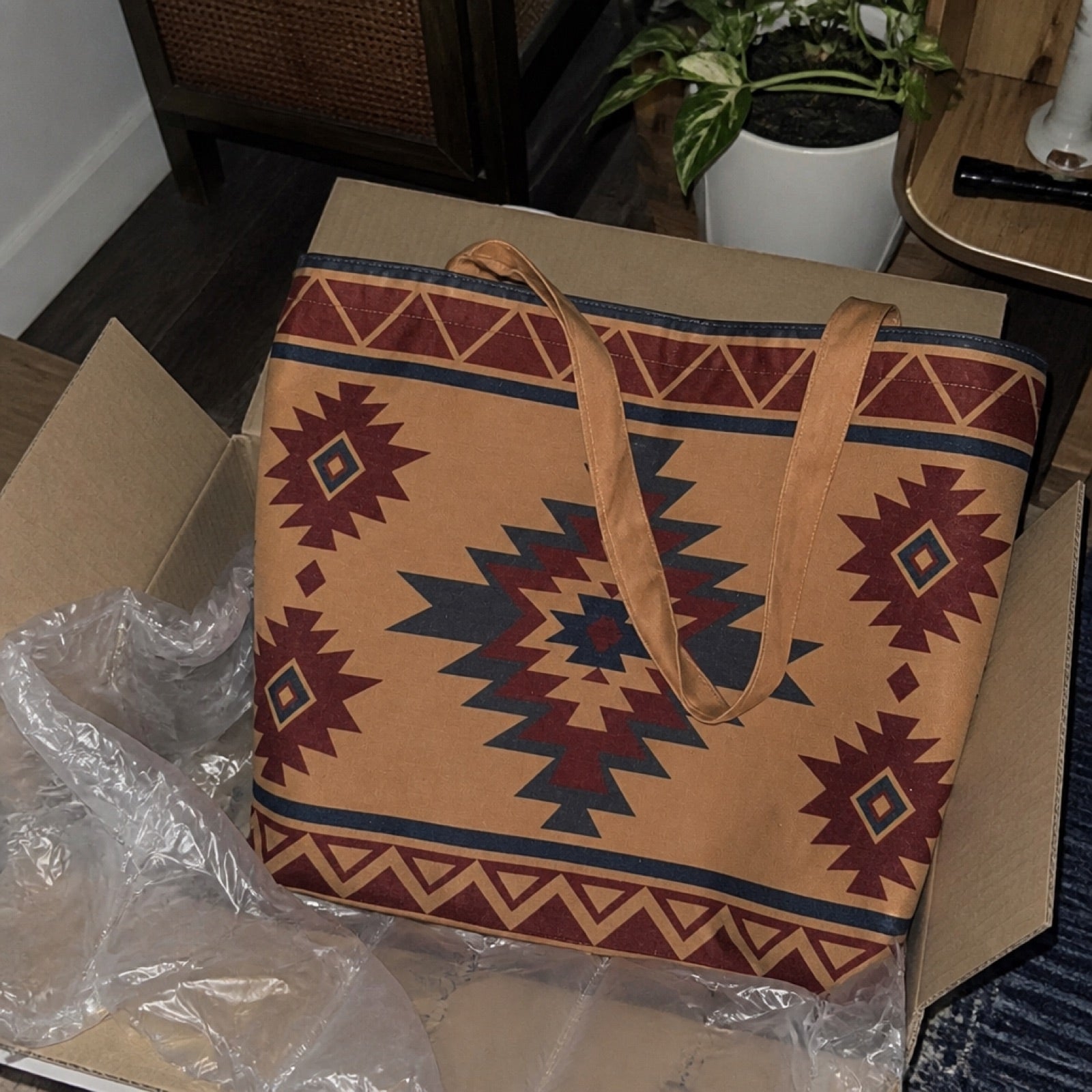 Boho tote bag packed with beach gear on a table