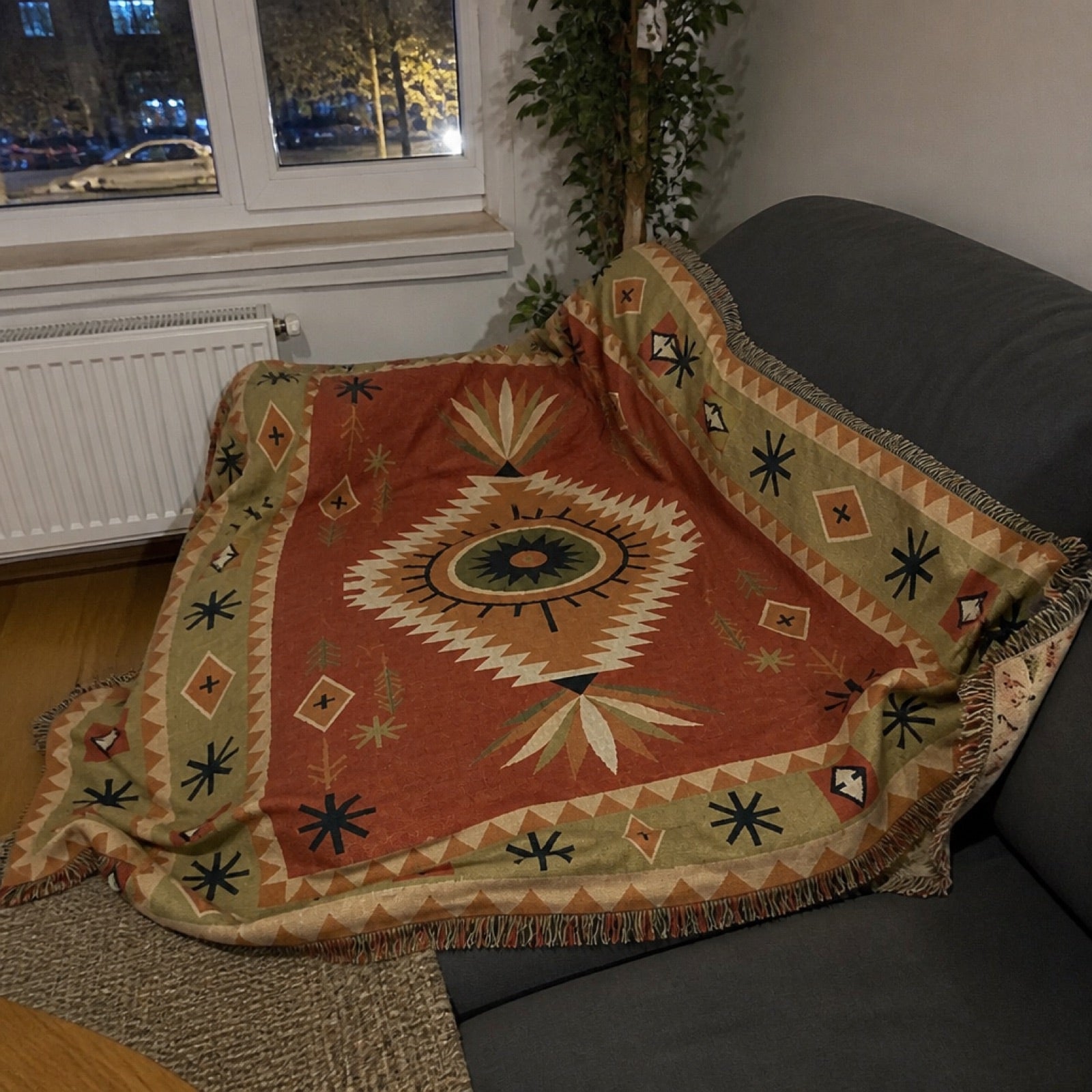 Woven jacquard throw blanket draped over furniture