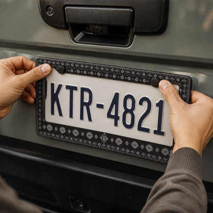 Karma license plate frames — black and grey zinc alloy frame, angle view | Solara