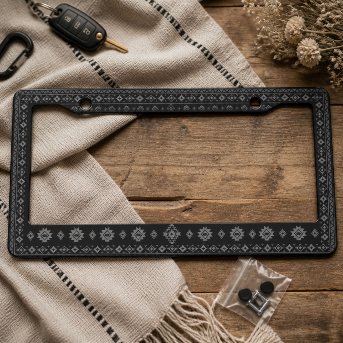 Karma license plate frames — monochrome Aztec pattern close-up | Solara
