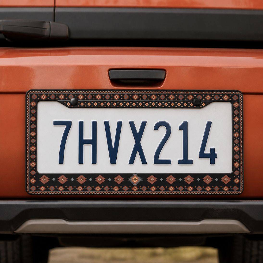 Zara license plate frames (set of 2) — black and terracotta Aztec zinc alloy frame, front view | Solara