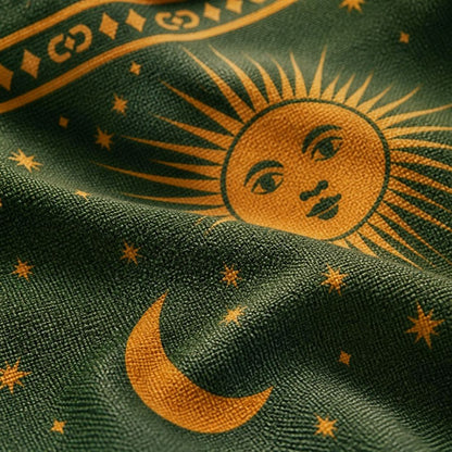 Macro detail of the Astra weave — crescent moon and stars in gold on green