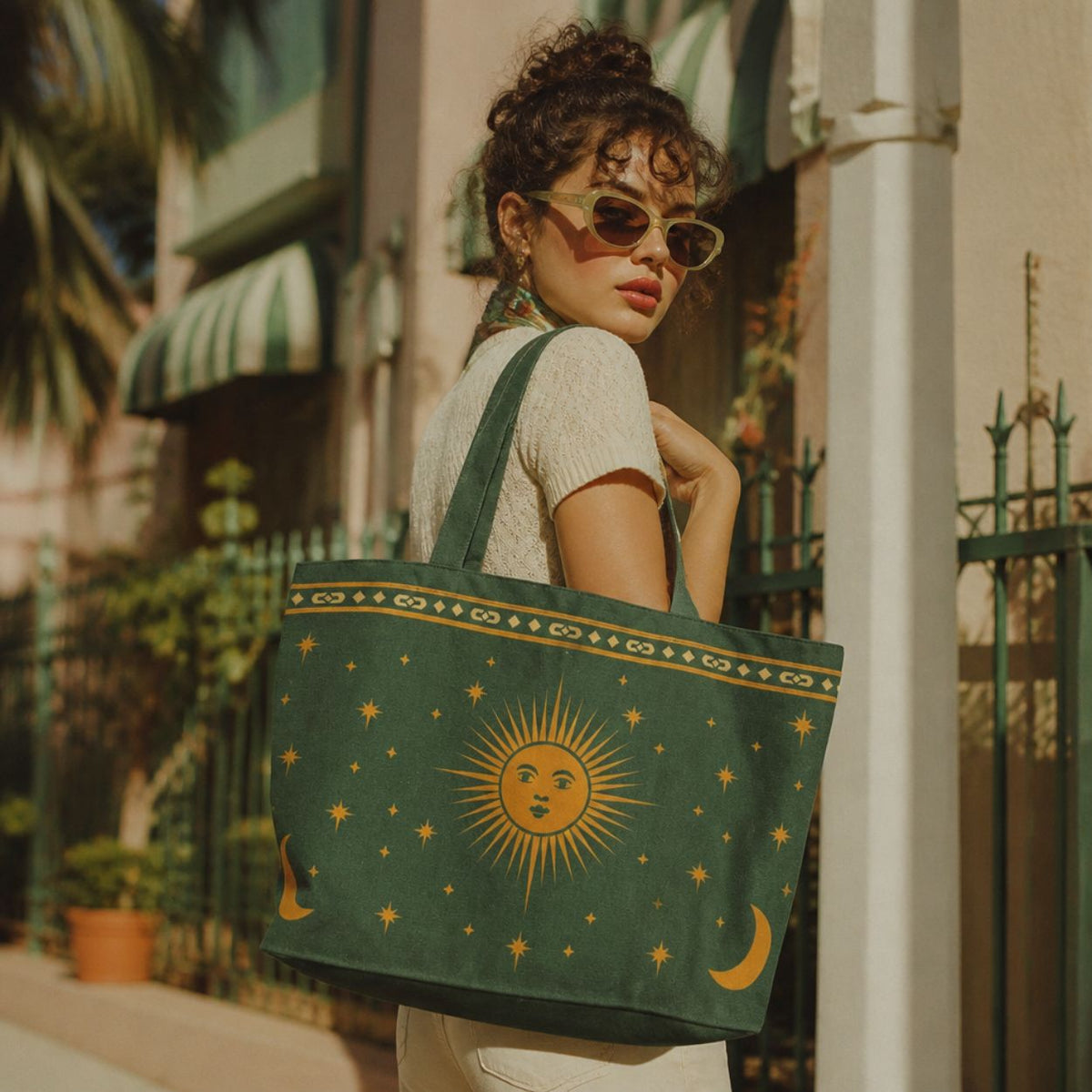 Astra celestial tote bag over the shoulder on a sunny street