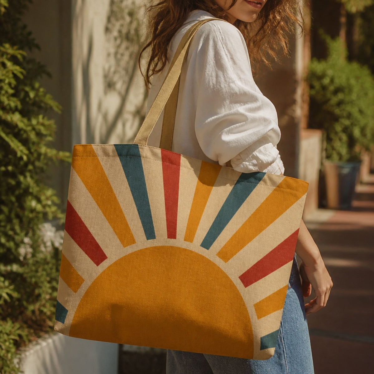 Aurora retro sunburst tote bag carried over the shoulder in a white blouse