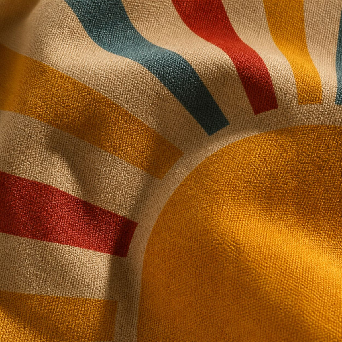 Close-up of the Aurora print — sun rays in red, teal and mustard on woven canvas