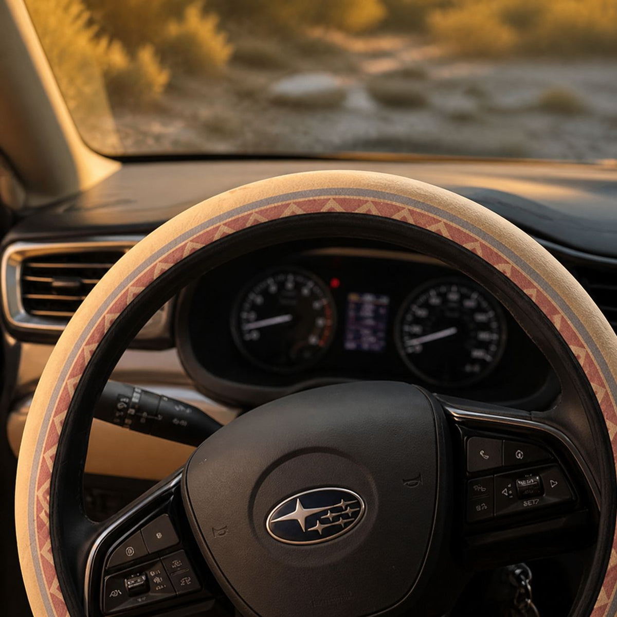 Top of the Indigo steering wheel cover by Solara over the dashboard gauges, cream Aztec print