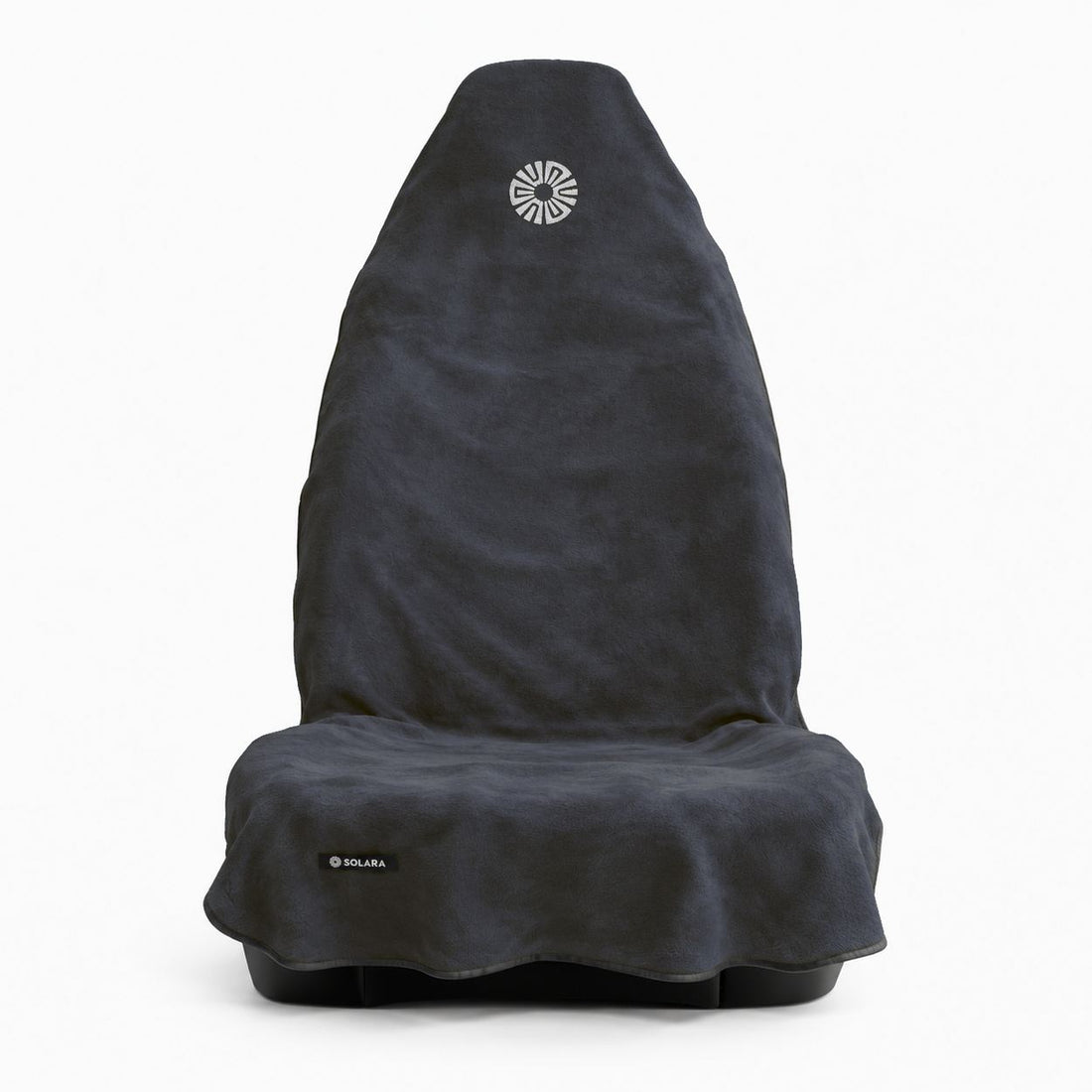 Neblina grey car seat towel by Solara on a front car seat, front view with the embroidered sun logo on the hood