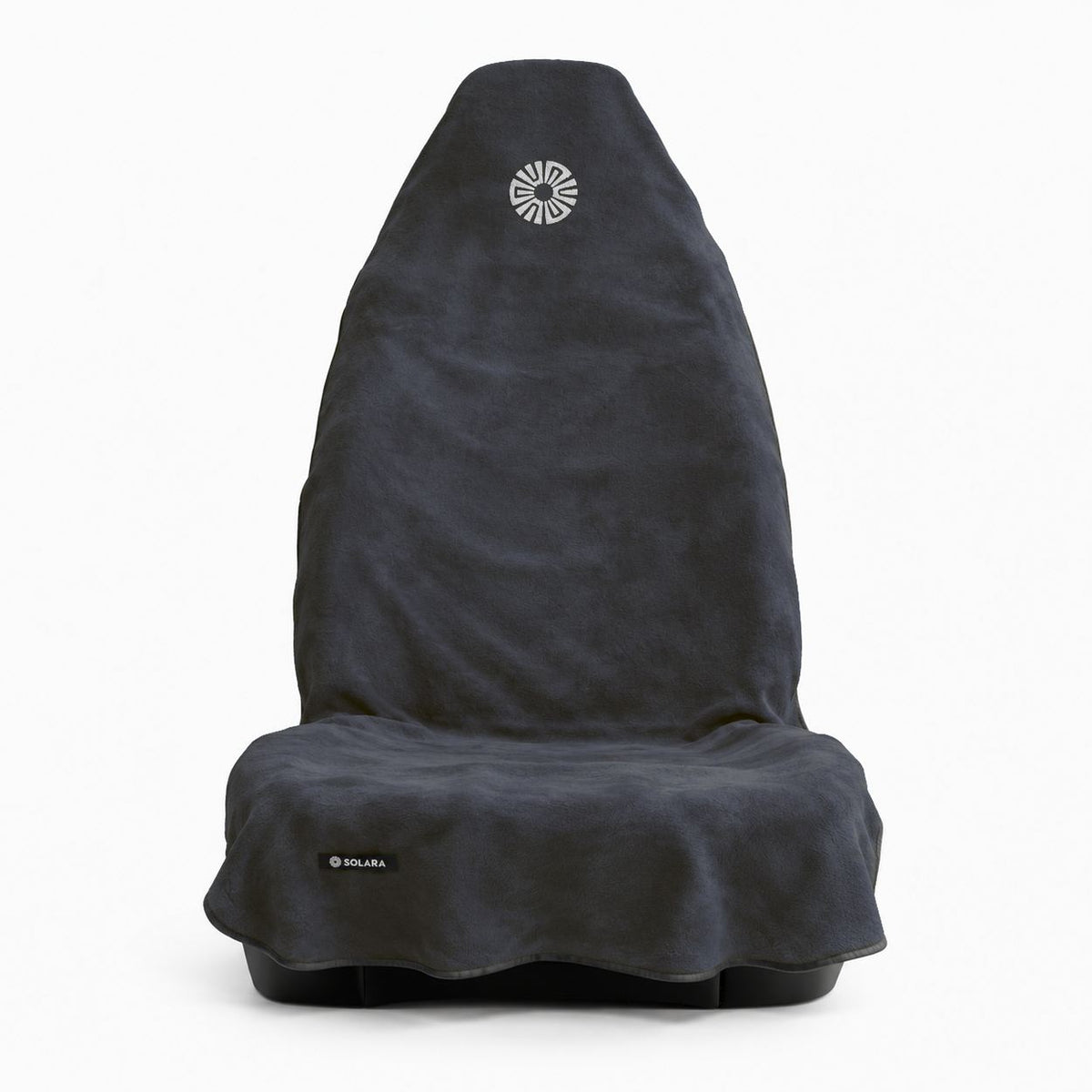 Neblina grey car seat towel by Solara on a front car seat, front view with the embroidered sun logo on the hood