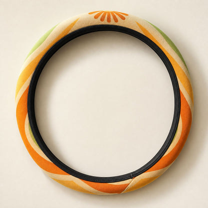 Ripple steering wheel cover by Solara laid flat: tangerine, mustard, olive and cream wave print with a black inner band