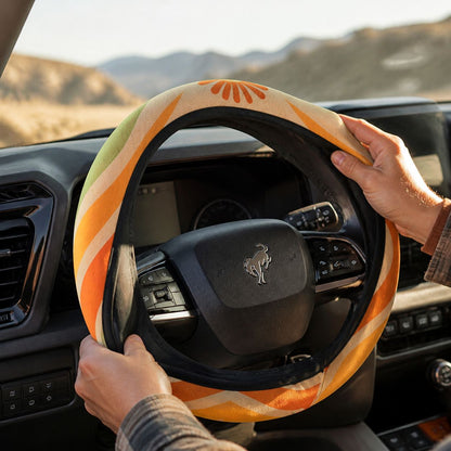 Slipping the Ripple steering wheel cover by Solara onto the steering wheel