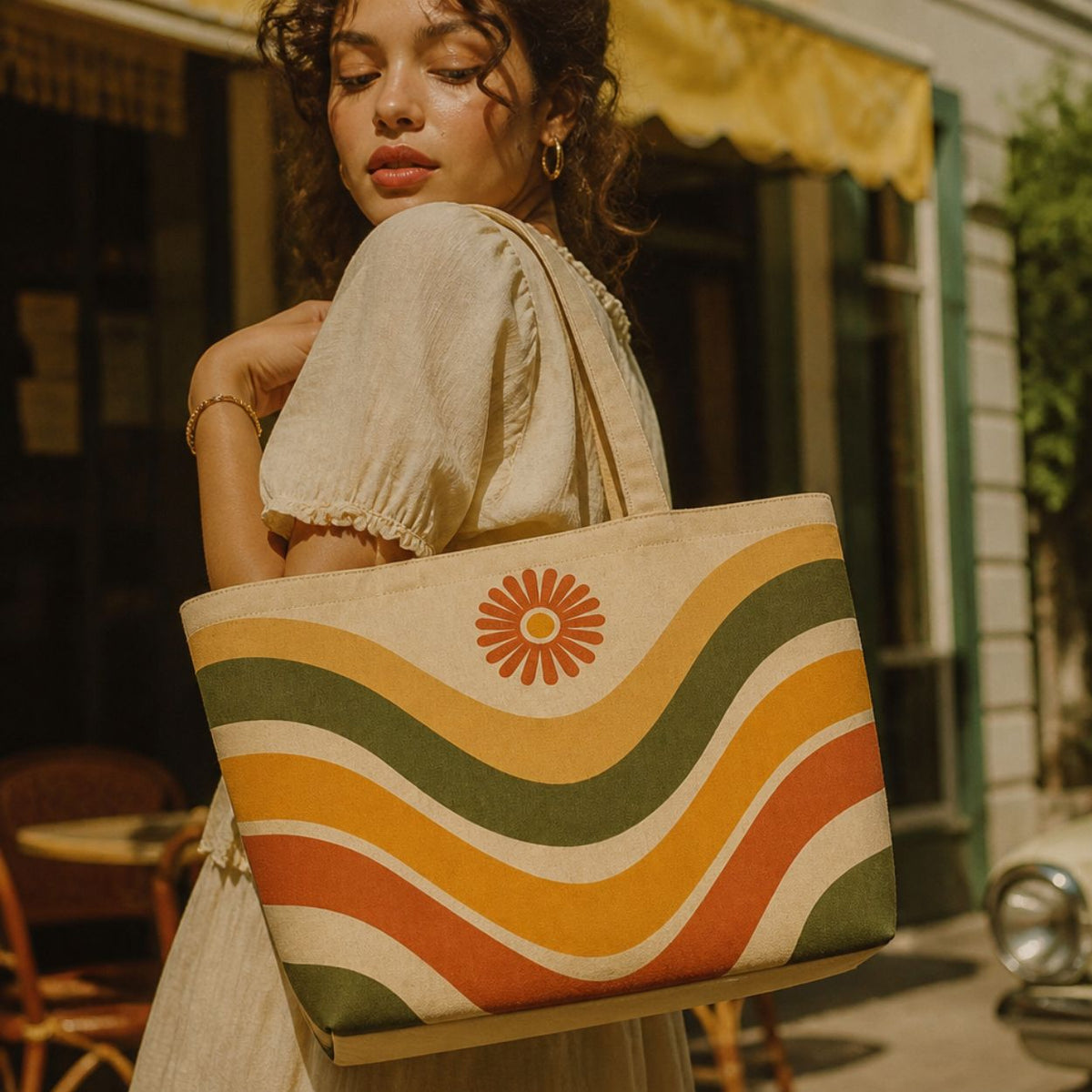 Ripple wave-print tote bag carried over the shoulder outside a café