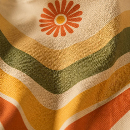 Close-up of the Ripple print — orange daisy above flowing retro waves