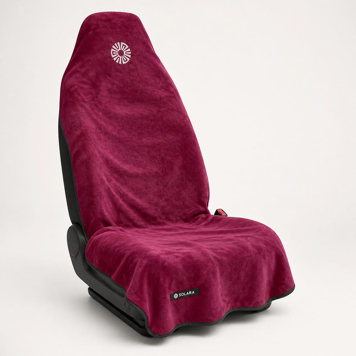Rosa pink car seat towel by Solara on a car seat, angled view from the left