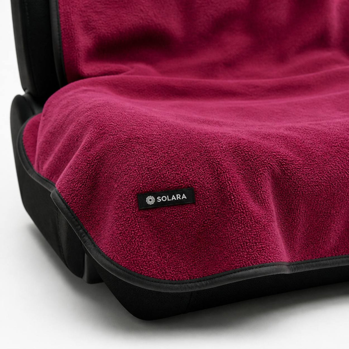 Detail of the bound edge and Solara label on the Rosa pink car seat towel