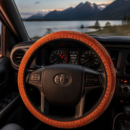 Sol steering wheel cover by Solara on the wheel at dusk, lake and mountain view