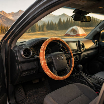 Car cabin through the open door with the Sol steering wheel cover by Solara on the wheel