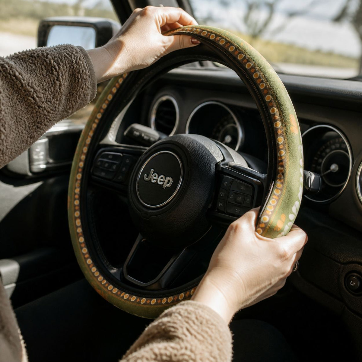 Slipping the Woodstock steering wheel cover by Solara onto the steering wheel